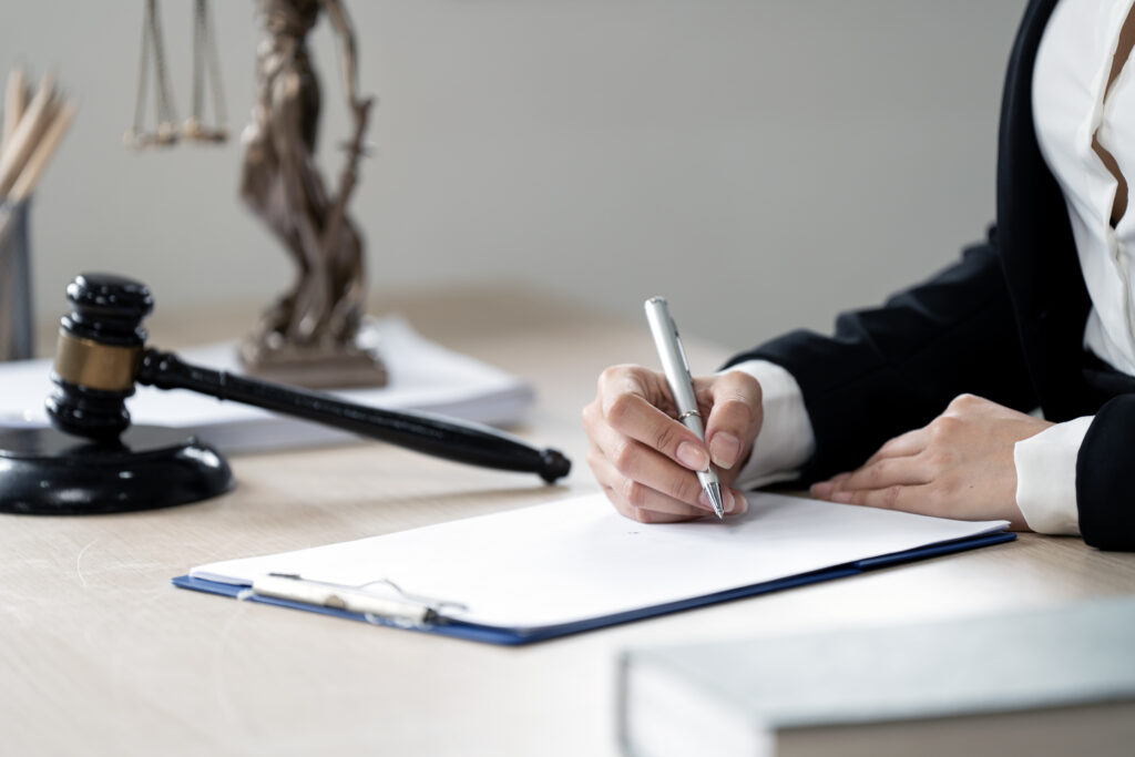 A person in a suit writing a lawyer debt collection letter